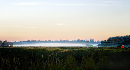 Red barn in Skagit Valley with fog settling over open field at dusk – Fred Gerendasy Photography