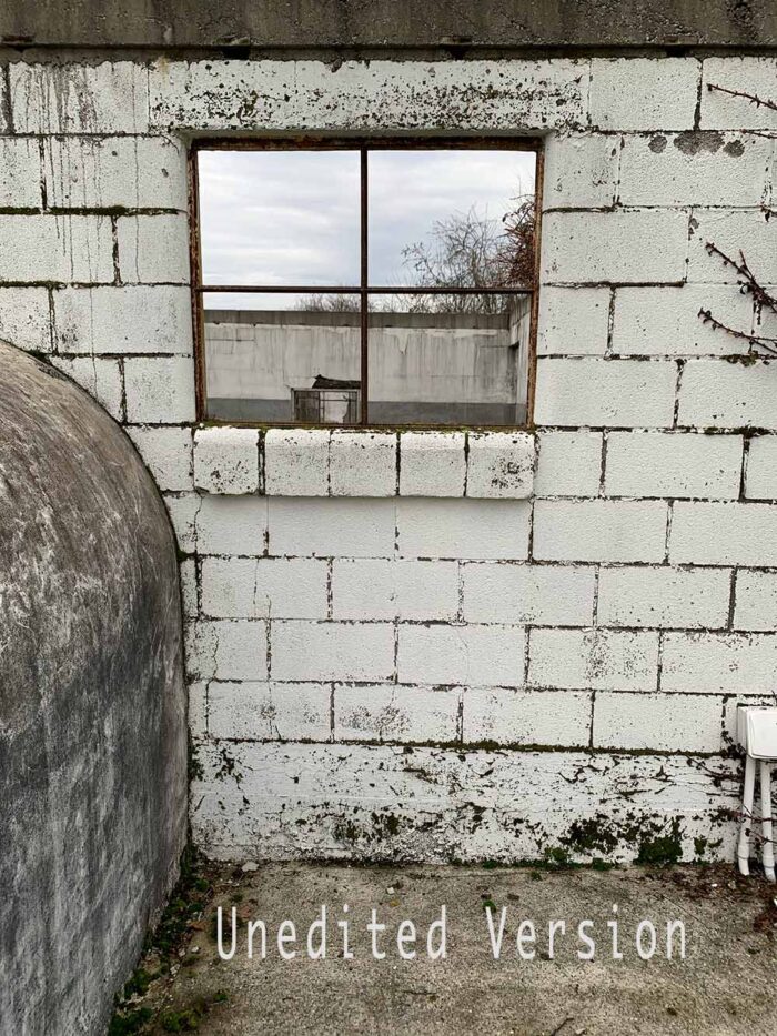 Unedited Milking Parlour Remains print by Fred Gerendasy Photography – fine art depiction of decaying dairy barn bathed in natural light, mounted in museum-quality frame