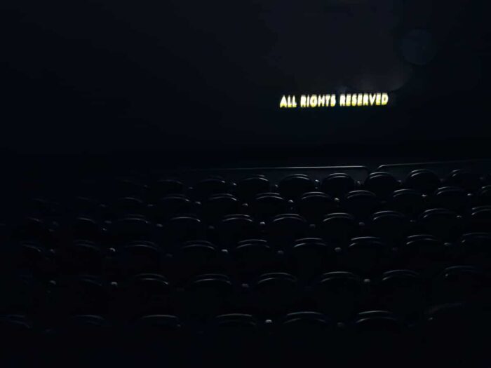 Empty seats in an old movie theater after the credits roll – fine art photo by Fred Gerendasy Photography capturing cinematic nostalgia