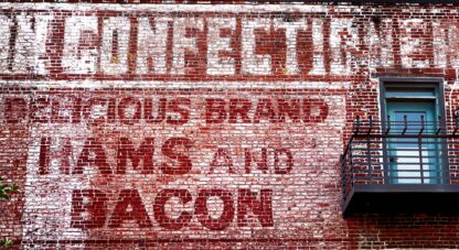 Hams and Bacon on the Brick Wall archival pigment print by Fred Gerendasy Photography – textured close-up of aged red brick with organic, abstract patterns