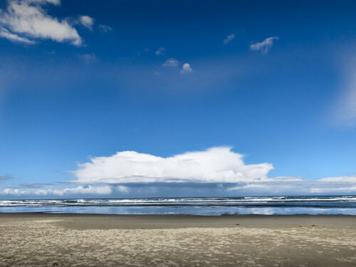 Cloud hovers gently above shore