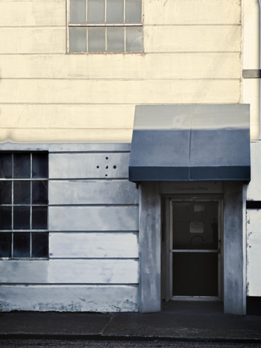 Corporate office building in partial sun in an earlier era