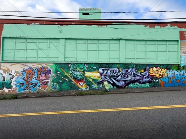 yellow divider in row in front of graffiti