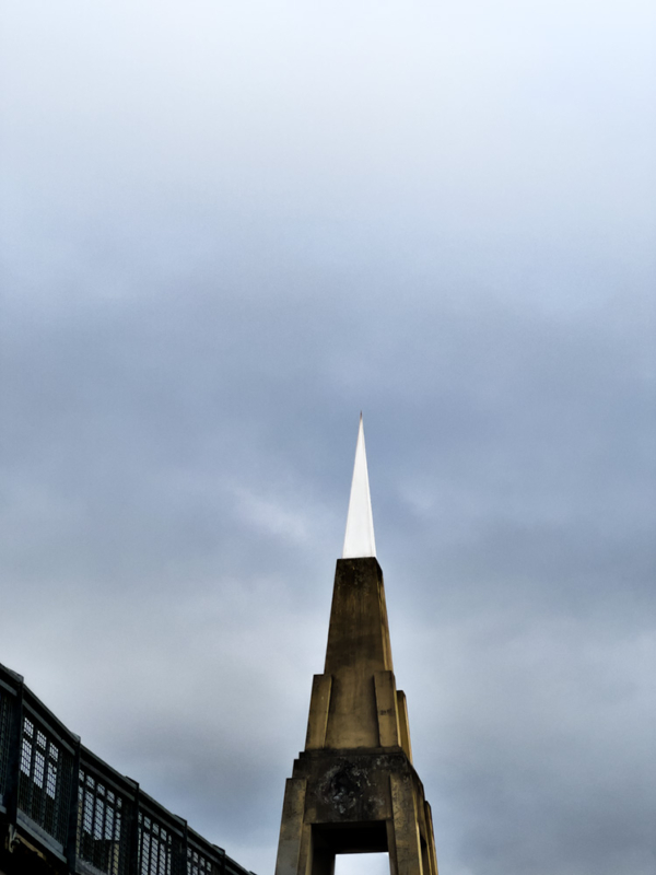 Cement tower with white triangular tower on top