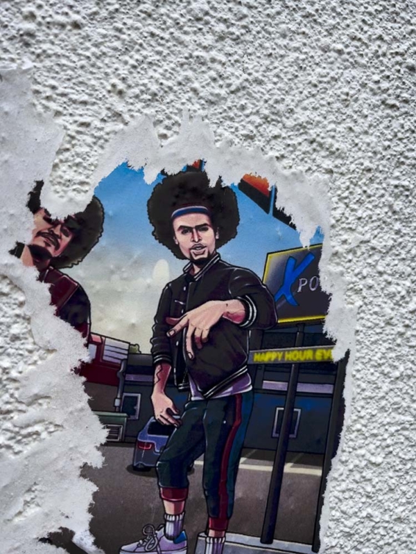 Partially torn out drawing on stucco wall.